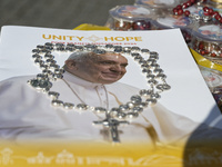 The photo shows a book with the image of Pope Francis and a Rosary during the general audience of Pope Francis in St. Peter's Square, at the...