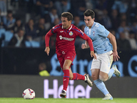 Anastasios Douvikas of RC Celta de Vigo competes for the ball with Luis Milla of Getafe CF during the La Liga EA Sports match between RC Cel...