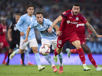 Javier Manquillo of RC Celta de Vigo competes for the ball with Diego Rico of Getafe CF during the La Liga EA Sports match between RC Celta...