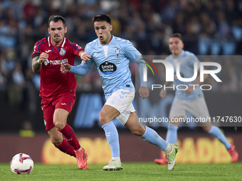 Alex Sola of Getafe CF competes for the ball with Hugo Sotelo of RC Celta de Vigo during the La Liga EA Sports match between RC Celta de Vig...