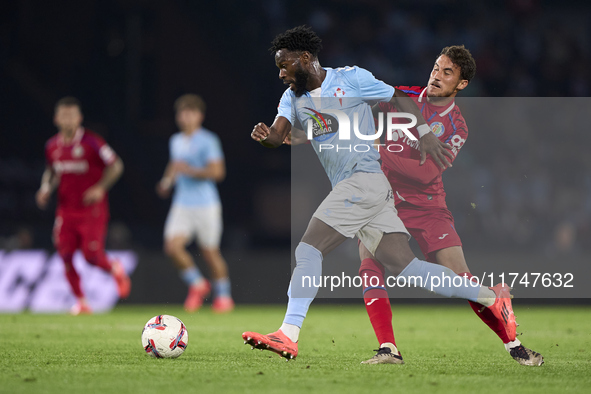 Luis Milla of Getafe CF competes for the ball with Jonathan Bamba of RC Celta de Vigo during the La Liga EA Sports match between RC Celta de...