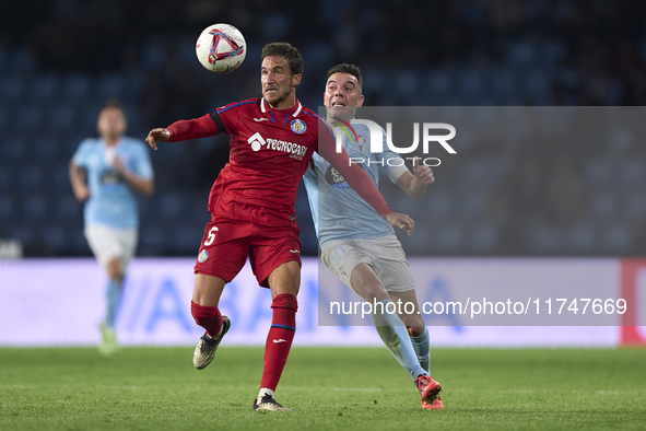 Iago Aspas of RC Celta de Vigo competes for the ball with Luis Milla of Getafe CF during the La Liga EA Sports match between RC Celta de Vig...