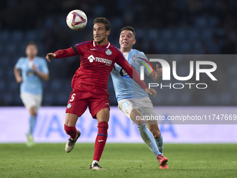 Iago Aspas of RC Celta de Vigo competes for the ball with Luis Milla of Getafe CF during the La Liga EA Sports match between RC Celta de Vig...