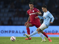 Alvaro Rodriguez of Getafe CF competes for the ball with Hugo Sotelo of RC Celta de Vigo during the La Liga EA Sports match between RC Celta...