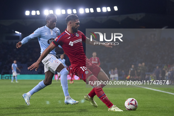 Ilaix Moriba of RC Celta de Vigo competes for the ball with Omar Alderete of Getafe CF during the La Liga EA Sports match between RC Celta d...