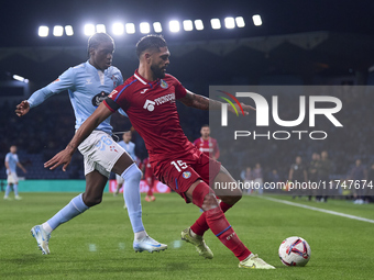 Ilaix Moriba of RC Celta de Vigo competes for the ball with Omar Alderete of Getafe CF during the La Liga EA Sports match between RC Celta d...