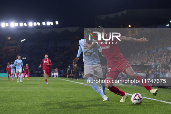 Ilaix Moriba of RC Celta de Vigo competes for the ball with Omar Alderete of Getafe CF during the La Liga EA Sports match between RC Celta d...