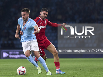 Juan Iglesias of Getafe CF competes for the ball with Oscar Mingueza of RC Celta de Vigo during the La Liga EA Sports match between RC Celta...