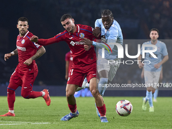 Juan Iglesias of Getafe CF competes for the ball with Ilaix Moriba of RC Celta de Vigo during the La Liga EA Sports match between RC Celta d...