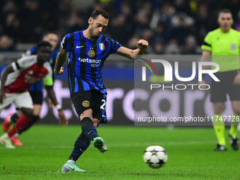 Hakan Calhanoglu of Inter Milan scores a goal during the Champions League match between Inter Milan and Arsenal at San Siro Stadium in Berga...