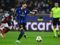 Hakan Calhanoglu of Inter Milan scores a goal during the Champions League match between Inter Milan and Arsenal at San Siro Stadium in Berga...