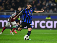 Hakan Calhanoglu of Inter Milan scores a goal during the Champions League match between Inter Milan and Arsenal at San Siro Stadium in Berga...