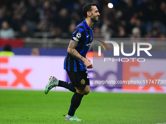 Hakan Calhanoglu of Inter Milan celebrates after scoring his team's first goal during the Champions League match between Inter Milan and Ars...