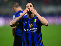 Hakan Calhanoglu of Inter Milan celebrates after scoring his team's first goal during the Champions League match between Inter Milan and Ars...