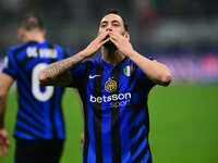 Hakan Calhanoglu of Inter Milan celebrates after scoring his team's first goal during the Champions League match between Inter Milan and Ars...