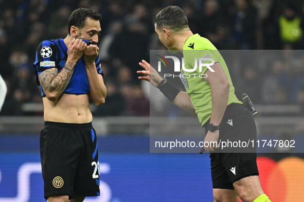 Hakan Calhanoglu of F.C. Inter and Referee Istvan Kovacs (ROU) are present during the UEFA Champions League 2024/25 League Phase MD4 match b...