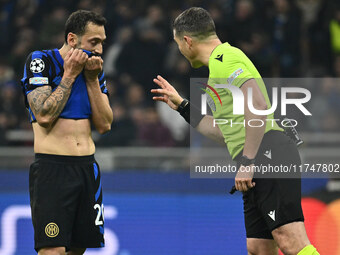 Hakan Calhanoglu of F.C. Inter and Referee Istvan Kovacs (ROU) are present during the UEFA Champions League 2024/25 League Phase MD4 match b...