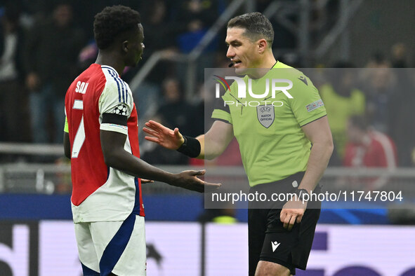 Bukayo Saka of Arsenal F.C. and Referee Istvan Kovacs (ROU) are present during the UEFA Champions League 2024/25 League Phase MD4 match betw...