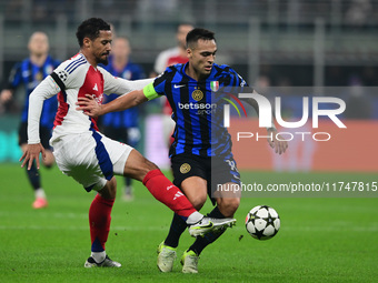 Gabriel Magalhaes of Arsenal and Lautaro Martinez of Inter Milan participate in the Champions League match between Inter Milan and Arsenal a...