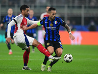 Gabriel Magalhaes of Arsenal and Lautaro Martinez of Inter Milan participate in the Champions League match between Inter Milan and Arsenal a...