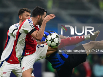 William Saliba of Arsenal touches the ball with his arm during the Champions League match between Inter Milan and Arsenal at San Siro Stadiu...