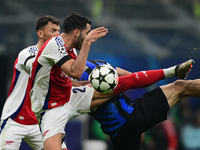 William Saliba of Arsenal touches the ball with his arm during the Champions League match between Inter Milan and Arsenal at San Siro Stadiu...