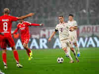 Joshua Kimmich of Bayern Munich  controls the ball during the Champions League Round 4 match between Bayern Munich v Benfica at the Allianz...