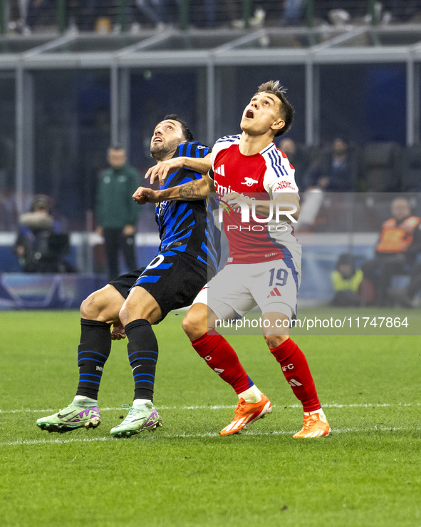 Leandro Trossard and Hakan Calhanoglu play during the UEFA Champions League 2024/25 match between FC Internazionale and FC Arsenal in Milano...