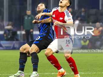 Leandro Trossard and Hakan Calhanoglu play during the UEFA Champions League 2024/25 match between FC Internazionale and FC Arsenal in Milano...