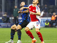 Leandro Trossard and Hakan Calhanoglu play during the UEFA Champions League 2024/25 match between FC Internazionale and FC Arsenal in Milano...