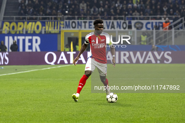 Bukayo Saka plays during the UEFA Champions League 2024/25 match between FC Internazionale and FC Arsenal at Stadio Giuseppe Meazza in Milan...