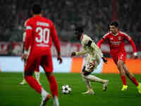 Alphonso Davies of Bayern Munich  controls the ball during the Champions League Round 4 match between Bayern Munich v Benfica at the Allianz...