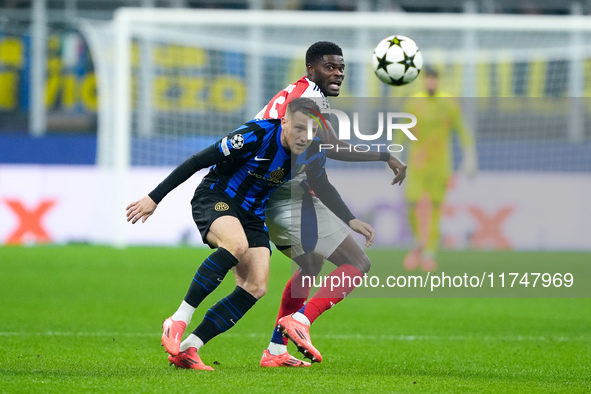 Piotr Zielinski of FC Internazionale and Thomas Partey of Arsenal compete for the ball during the UEFA Champions League 2024/25 League Phase...