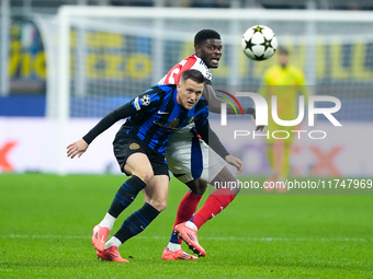 Piotr Zielinski of FC Internazionale and Thomas Partey of Arsenal compete for the ball during the UEFA Champions League 2024/25 League Phase...