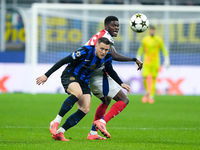 Piotr Zielinski of FC Internazionale and Thomas Partey of Arsenal compete for the ball during the UEFA Champions League 2024/25 League Phase...