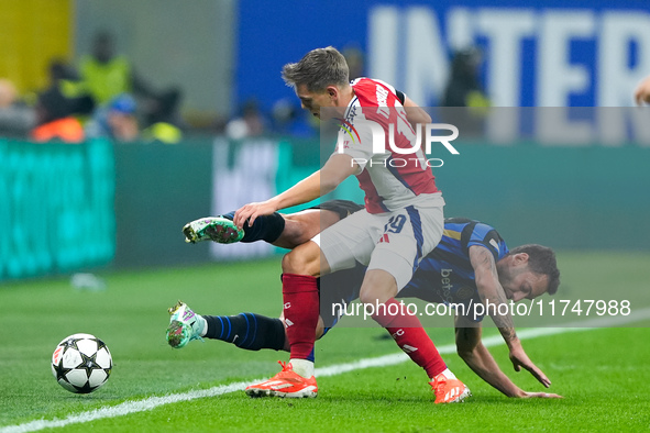 Hakan Calhanoglu of FC Internazionale and Leandro Trossard of Arsenal compete for the ball during the UEFA Champions League 2024/25 League P...