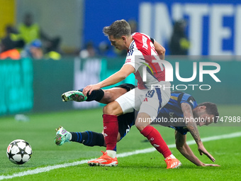 Hakan Calhanoglu of FC Internazionale and Leandro Trossard of Arsenal compete for the ball during the UEFA Champions League 2024/25 League P...