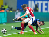 Hakan Calhanoglu of FC Internazionale and Leandro Trossard of Arsenal compete for the ball during the UEFA Champions League 2024/25 League P...