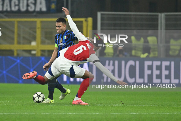 Lautaro Martinez of F.C. Inter and Gabriel of Arsenal F.C. are in action during the UEFA Champions League 2024/25 League Phase MD4 match bet...