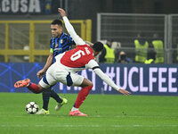 Lautaro Martinez of F.C. Inter and Gabriel of Arsenal F.C. are in action during the UEFA Champions League 2024/25 League Phase MD4 match bet...