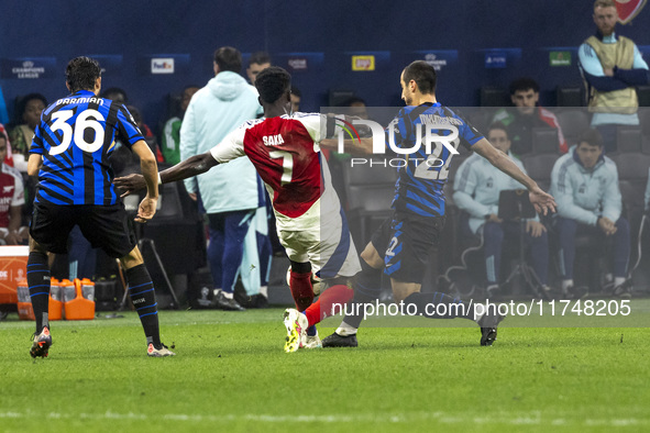 Bukayo Saka and Henrikh Mkhitaryan play during the UEFA Champions League 2024/25 match between FC Internazionale and FC Arsenal in Milano, I...