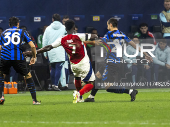 Bukayo Saka and Henrikh Mkhitaryan play during the UEFA Champions League 2024/25 match between FC Internazionale and FC Arsenal in Milano, I...