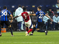 Bukayo Saka and Henrikh Mkhitaryan play during the UEFA Champions League 2024/25 match between FC Internazionale and FC Arsenal in Milano, I...