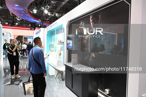 Visitors watch an introduction of the game ''Black Myth: Wukong'' at the 7th China International Import Expo in Shanghai, China, on November...