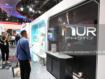 Visitors watch an introduction of the game ''Black Myth: Wukong'' at the 7th China International Import Expo in Shanghai, China, on November...