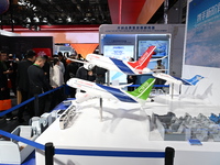 Visitors view models of C919 and C929 aircraft at the China Pavilion during the 7th China International Import Expo in Shanghai, China, on N...