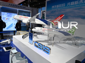 Visitors view models of C919 and C929 aircraft at the China Pavilion during the 7th China International Import Expo in Shanghai, China, on N...