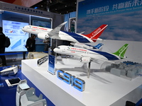 Visitors view models of C919 and C929 aircraft at the China Pavilion during the 7th China International Import Expo in Shanghai, China, on N...