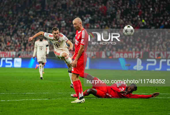 Joshua Kimmich of Bayern Munich  shoots on goal during the Champions League Round 4 match between Bayern Munich v Benfica at the Allianz are...