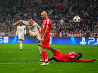 Joshua Kimmich of Bayern Munich  shoots on goal during the Champions League Round 4 match between Bayern Munich v Benfica at the Allianz are...